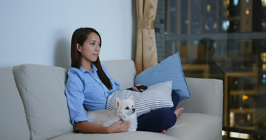 Women and dog watch tv together