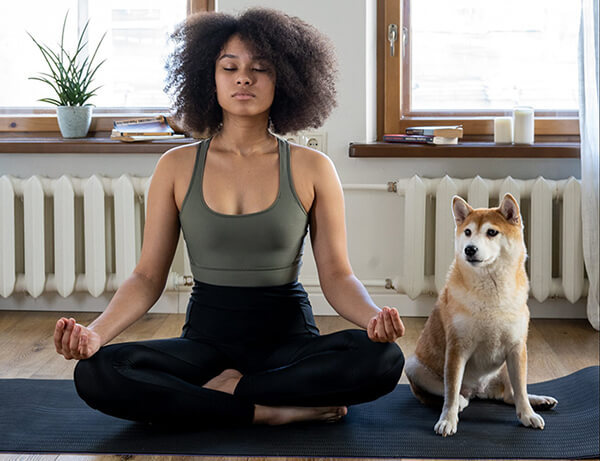women meditating with dog