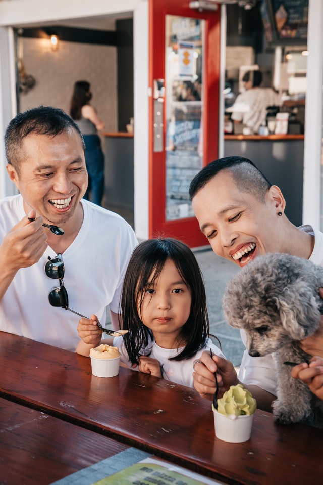 family with dog eating ice cream